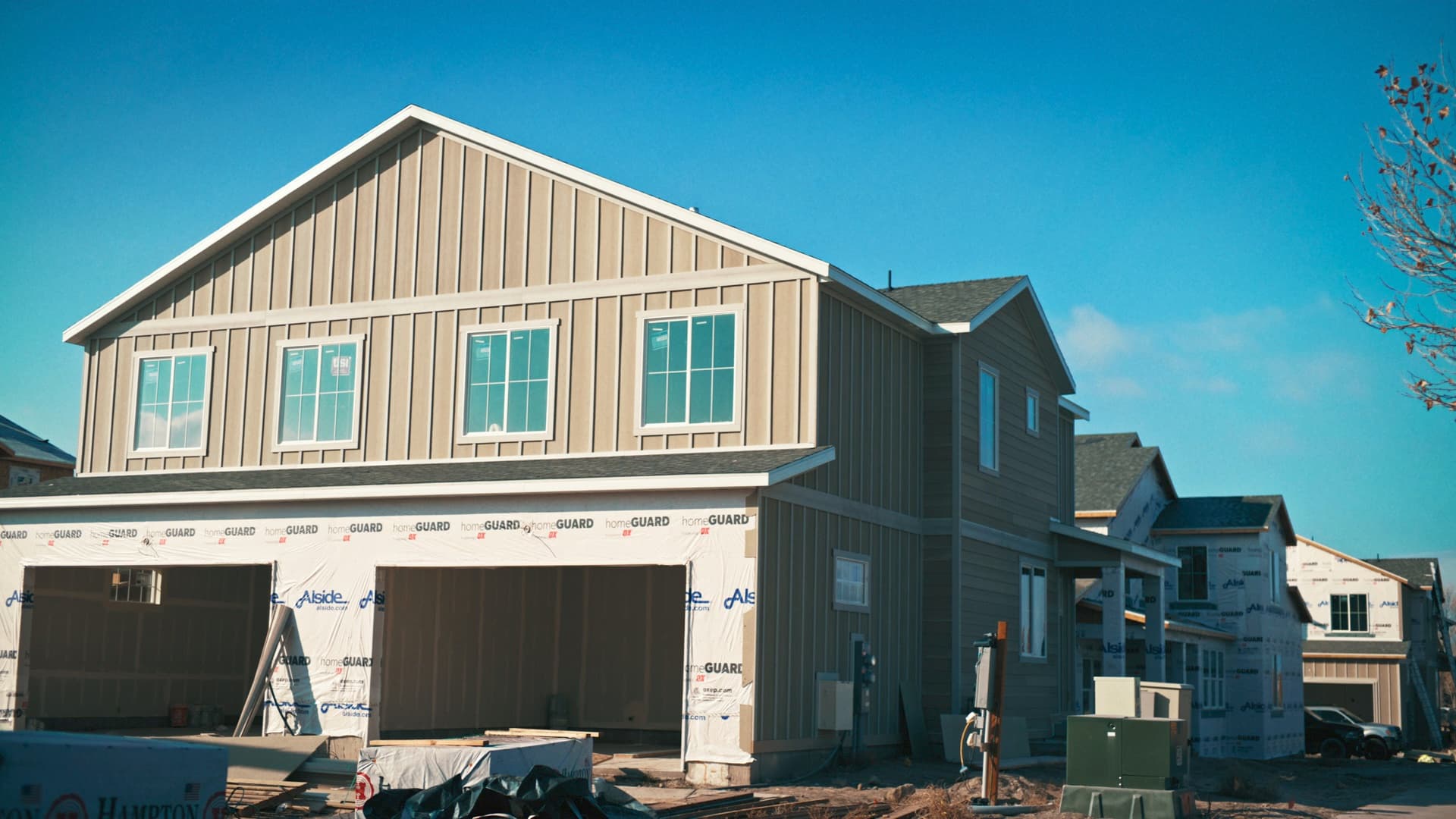 A house under construction, its garage still open to the street