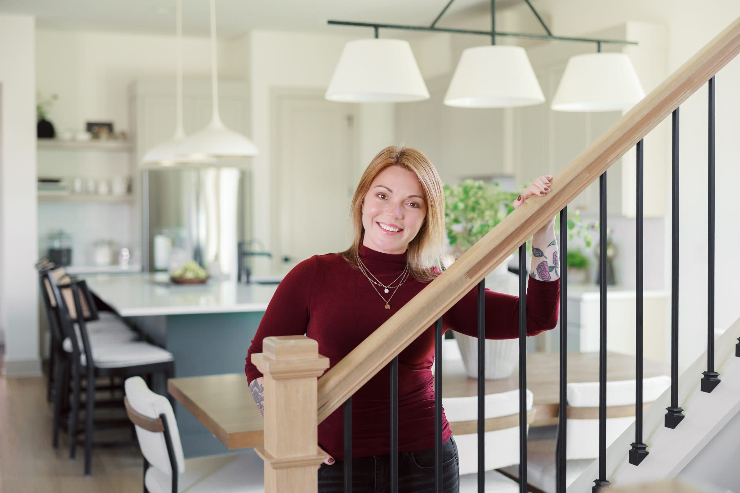 Jenna Gray, Dayton realtor, on the staircase of a Dayton area home