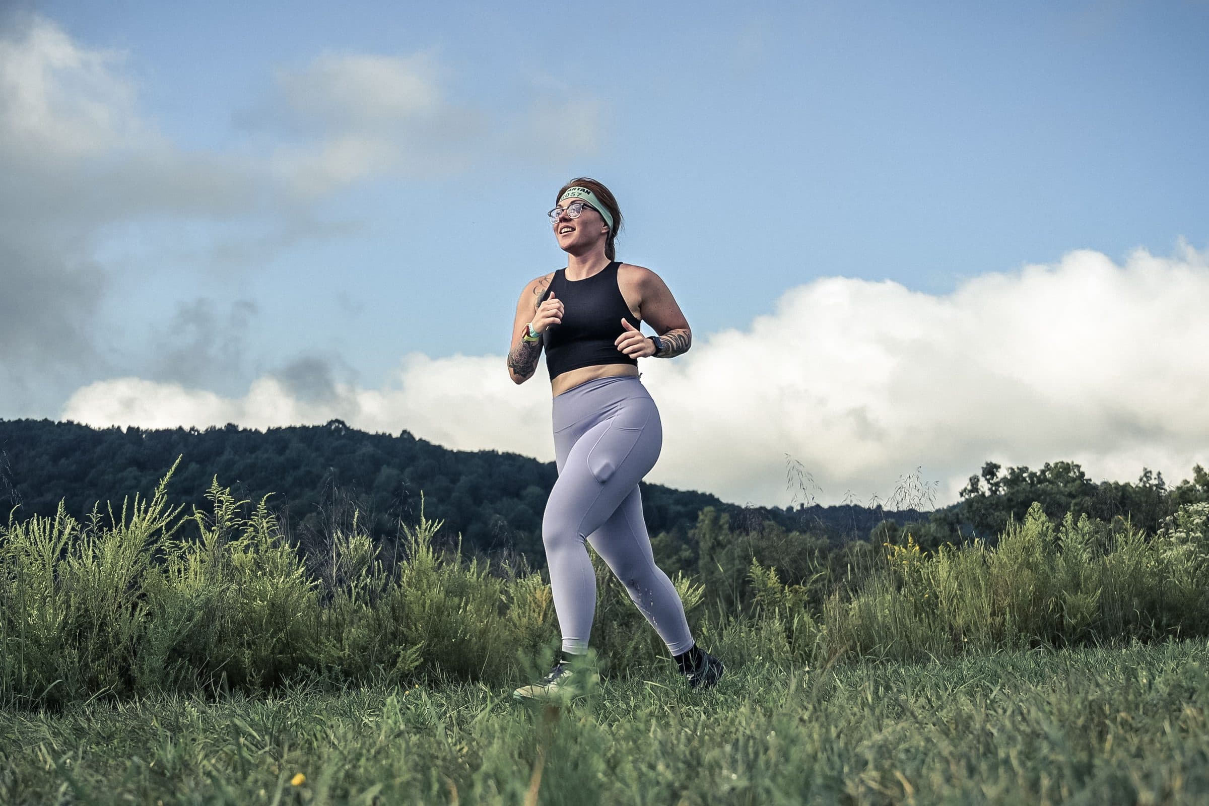 Jenna Gray, Dayton realtor, on a trail run under a wide sky